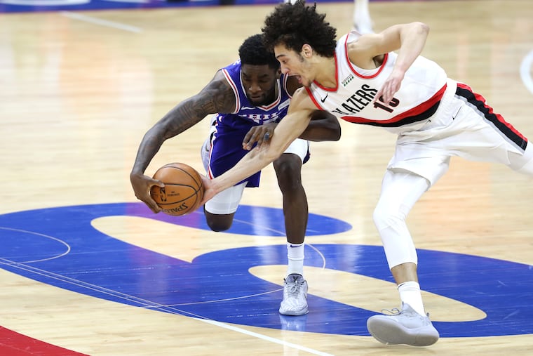 Shake Milton, left, of the SIxers has the ball stolen by CJ Elleby of the Trailblazers during the 2nd half of a NBA game at the Wells Fargo Center on Feb. 4, 2021.
