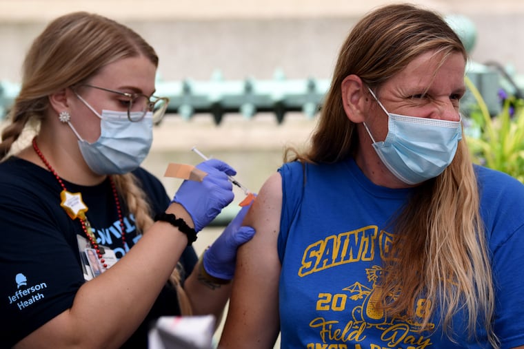 Lolly Rivas (right) gets a COVID-19 shot from Carrie Christiansen (left), a vaccination nurse with Jefferson Hospital, at City Hall on Sunday.