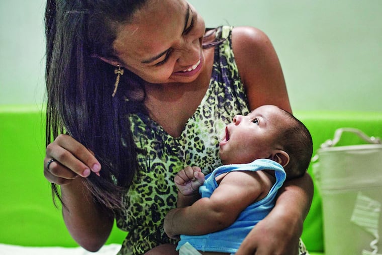 Amanda dos Santos , 19, with son Emanuel, 3 months, who was born with microcephaly in Brazil. She thinks she had the Zika virus early in her pregnancy. KATIE FALKENBERG / Los Angeles Times