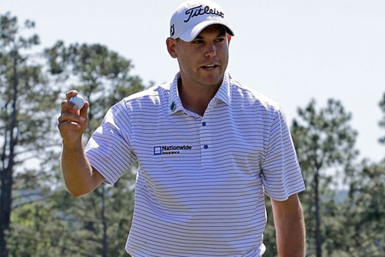 Bill Haas holds up his ball after a birdie putt on the 18th hole during the first round of the Masters golf tournament Thursday, April 10, 2014, in Augusta, Ga. (David J. Phillip/AP)