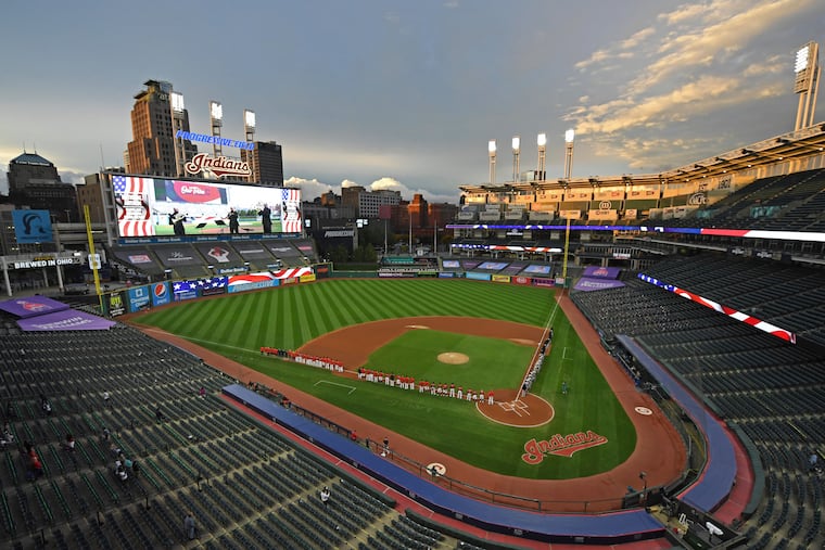 FILE - In this Sept. 29, 2020, file photo, players and coaches for the New York Yankees and the Cleveland Indians stand for the national anthem before Game 1 of an American League wild-card baseball series in Cleveland. The Indians are changing their name after 105 years, a person familiar with the decision told The Associated Press on Sunday, Dec. 13, 2020.