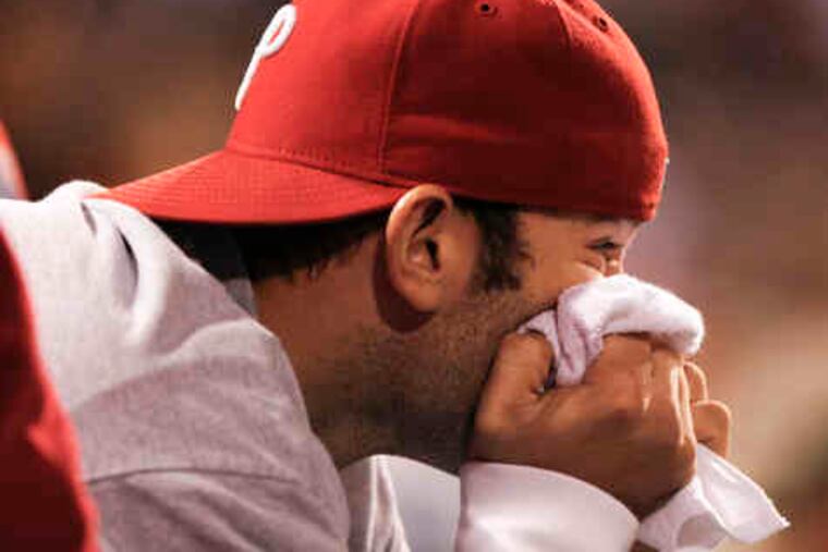A Phillies fan looks out onto the field at Citizens Bank Park after the Phillies lost the game, and the NLCS, to the Giants.