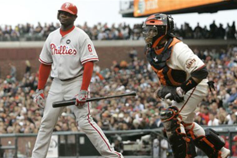 Ryan Howard, left, reacts after being called out on strikes against Giants pitcher Tim Lincecum in the first inning of last night's game in San Francisco. The Phillies lost, 2-0. At right is the Giants' Bengie Molina. (AP Photo/Jeff Chiu)