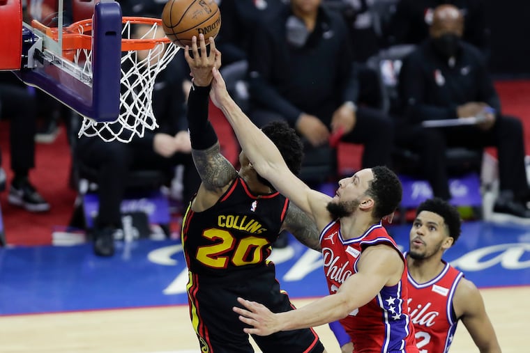 Sixers guard Ben Simmons attempts to block Atlanta Hawks forward John Collins' fast break lay-up attempt during the third quarter in Game 1 of the NBA Eastern Conference playoff semifinals on Sunday, June 6, 2021. No foul was called on the play.