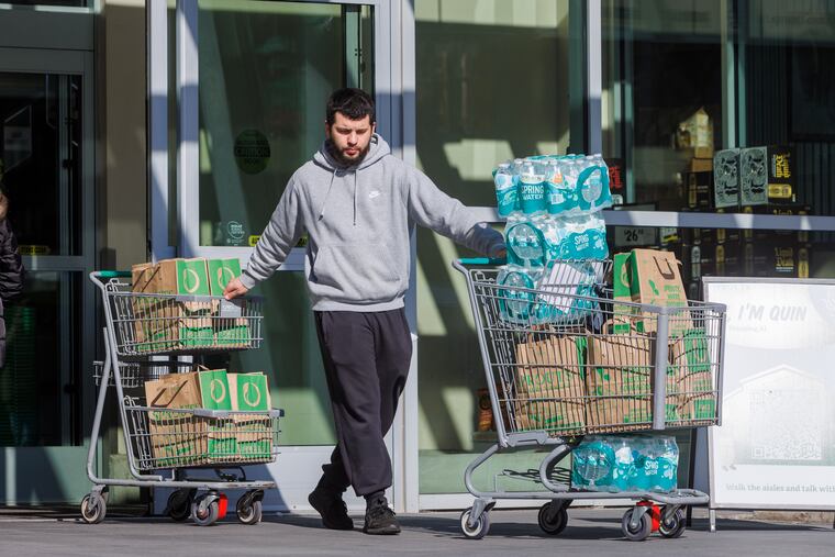 A customer buys water at Sprouts at South Broad and Carpenter in Philadelphia on Monday.