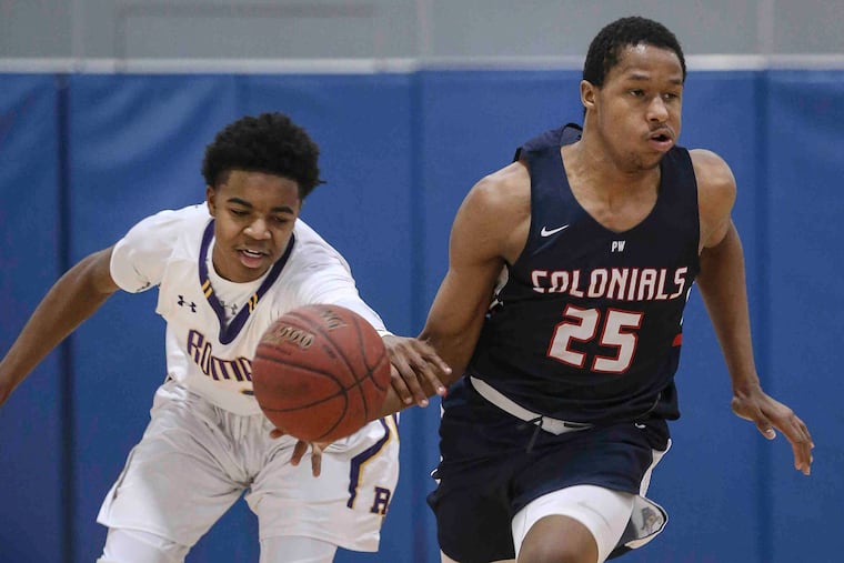 Roman Catholic's Hakim Hart, pictured knocking the ball away from Plymouth Whitemarsh's Ahmad Williams during a game back in March 2018, scored 29 points in a win against Archbishop Ryan on Friday.