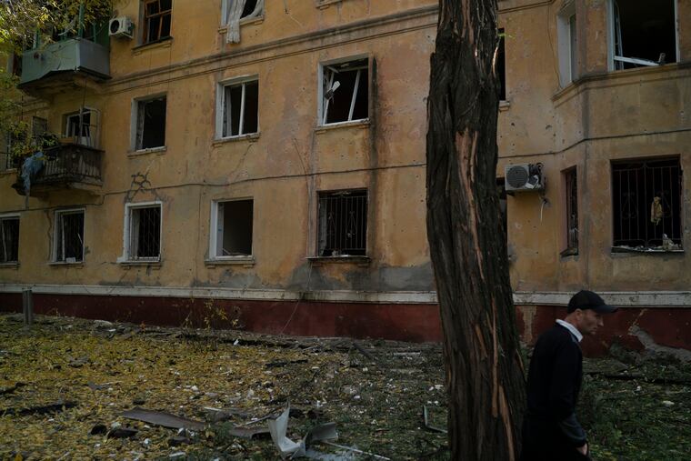 A man walks past a damaged building after a Russian attack in Kramatorsk, Ukraine, on Thursday.