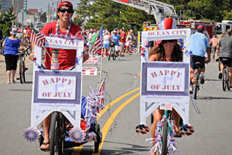 Greg and Maryann Monaghan, of the Roxborough section of Philadelphia, ride in the Ocean City bicycle parade dressed as Ocean City lifeguard stations. RON TARVER / Staff Photographer