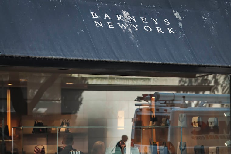 FILE - In this July 16, 2019, file photo a pedestrian reflect in a store window at Barneys department store in New York. has filed for Chapter 11 bankruptcy protection, becoming the latest retailer unable to withstand the consumer shift to online shopping and high rents. Barneys said it’ll use the bankruptcy process to review store leases to best optimize its operations. The company also announced Tuesday, Aug. 6, that it has secured $75 million in new capital to facilitate a going concern sale process.