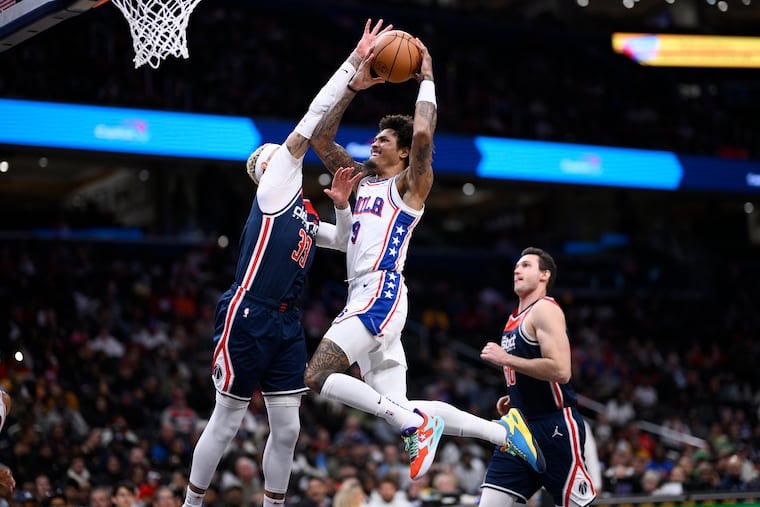 Kelly Oubre Jr. goes to the basket against Wizards' Kyle Kuzma and Danilo Gallinari during the second half on Wednesday. He finished with 12 points and three rebounds in 19:25 of action in his first game after being injured in a reported hit-and-run incident in Center City.