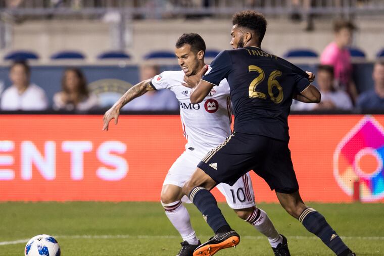 Toronto FC's Sebastian Giovinco, left, battles with Philadelphia Union's Auston Trusty as they go after the ball during the second half of an MLS soccer match Friday, June 8, 2018, in Chester, Pa. Toronto FC won 2-0. (AP Photo/Chris Szagola)