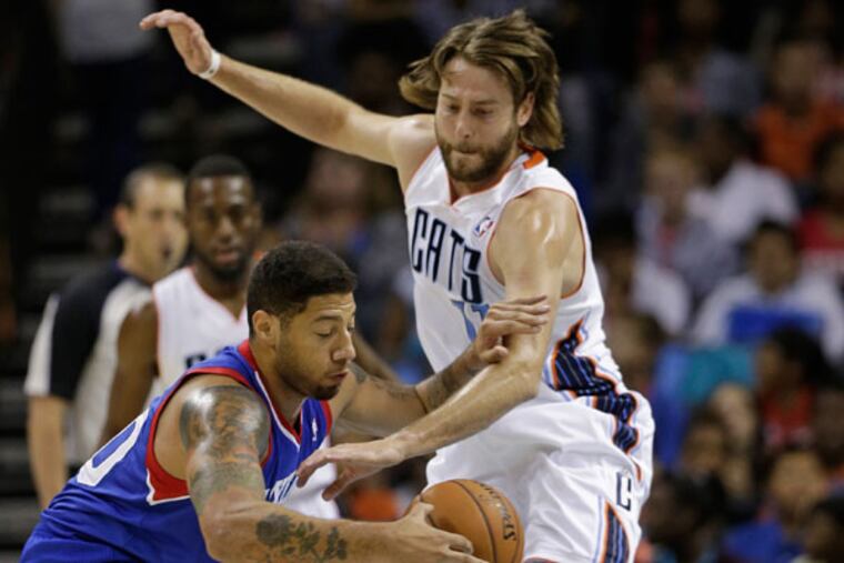 Charlotte Bobcats' Josh McRoberts, right, knocks the ball from Philadelphia 76ers' Royce White, left, during the first half of a preseason NBA basketball game in Charlotte, N.C., Thursday, Oct. 17, 2013. (Chuck Burton/AP)