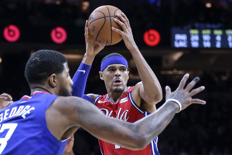 The Sixers' Tobias Harris looking to pass in front of the Clippers' Paul George on Tuesday.