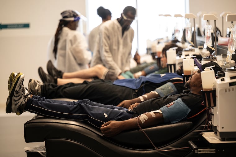 Wallace Smith sits in a recliner, alongside other people getting paid to donate plasma, at B Positive Plasma in Wyncote on Cheltenham Avenue. Donors can make an extra $500 or so a month. Inflation is driving higher donor numbers.