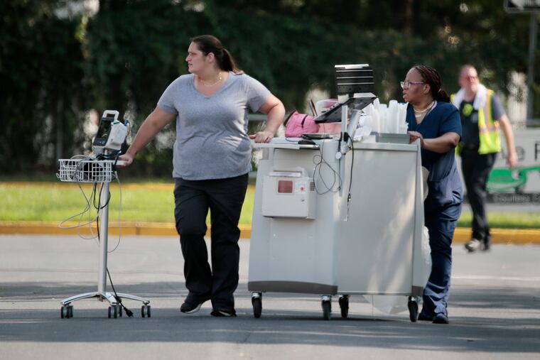 First responders evacuate residents from the Voorhees Care and Rehabilitation Center on Laurel Oak Road. The air conditioning system failed at the facility, requiring officials to evacuate 183 residents.