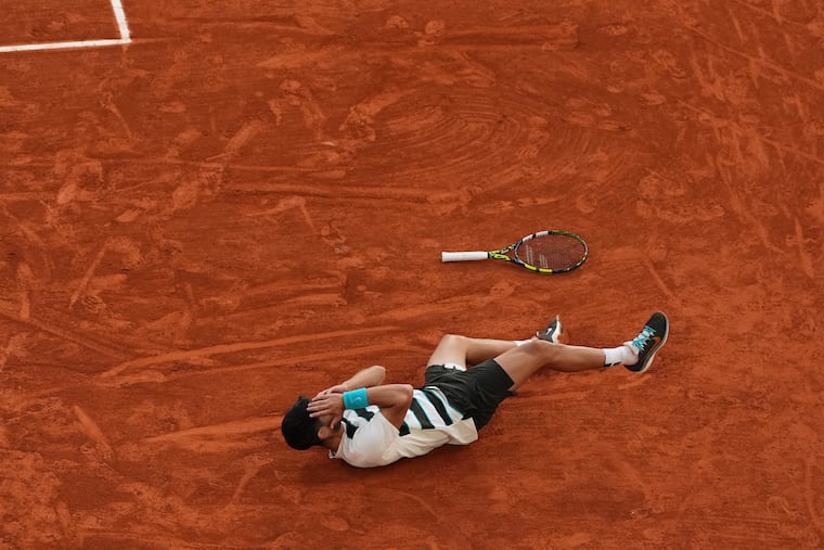 Spain's Carlos Alcaraz celebrates after winning the French Open championship in a marathon match with Jannik Sinner.