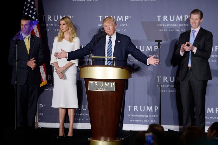 Then-presidential nominee Donald Trump speaks as sons Donald Trump Jr., Eric Trump, and daughter Ivanka Trump look on during the grand opening of the Trump International Hotel on Oct. 26, 2016 in Washington, D.C. Trump has sued to block Deutsche Bank AG and Capital One Financial Corp. from complying with congressional subpoenas targeting his bank records.
