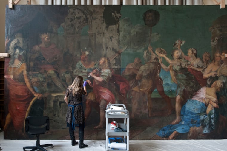 Kristin deGhetaldi, a conservator from the University of Delaware, works on restoring the 17th century deCortona painting at Villanova. (RON TARVER/Staff Photographer)