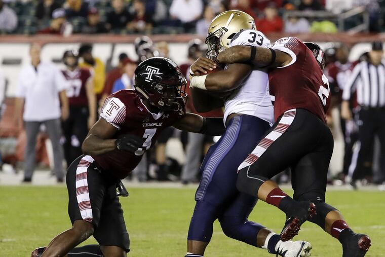Temple defensive back Delvon Randall (right) and defensive back Sean Chandler (left) stop Navy fullback Chris High on Thursday, November 2, 2017 in Philadelphia. YONG KIM / Staff Photographer
