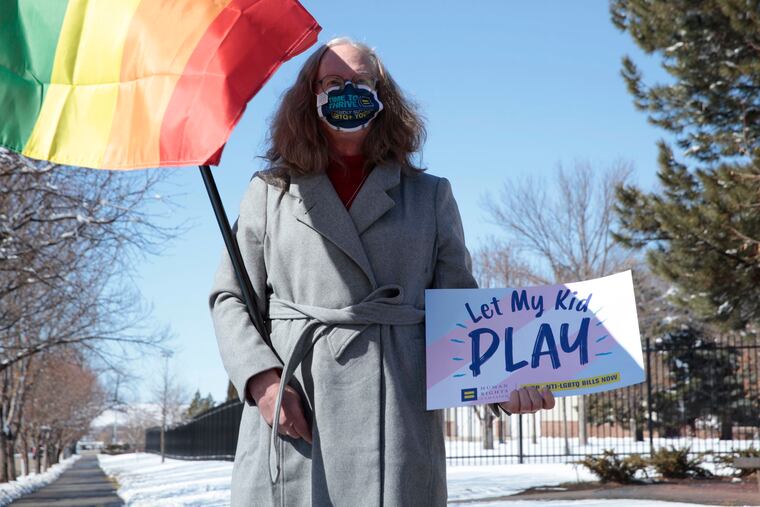 Stephanie Marty demonstrates against a proposed ban on transgender girls and women from female sports leagues outside the South Dakota governor's mansion in Pierre, S.D., last month. Similar legislation is proposed in Pennsylvania.
