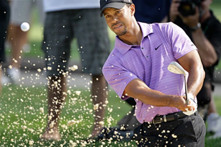 Tiger Woods hits from the sand trap to the 12th green at the Bridgestone Invitational tournament. (AP Photo/Amy Sancetta)