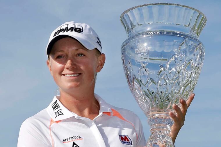 Stacy Lewis holds the championship trophy after winning the 2014 ShopRite LPGA Classic.