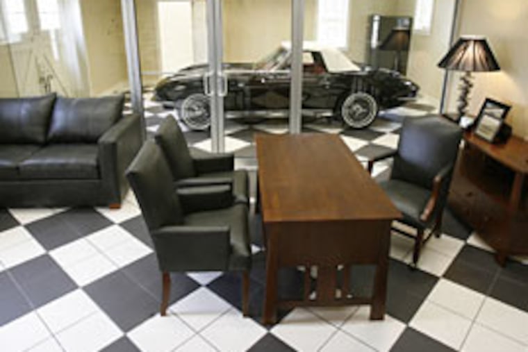 A glass viewing wall separates Ott's office from the bay for his '65 Corvette. He says the view is so distracting that he finds it harder to get his work done there.