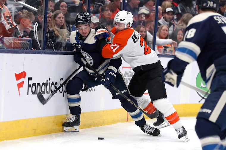 Columbus Blue Jackets center Alexandre Texier and Scott Laughton (right) of the Flyers vie for the puck during the second period Saturday night.