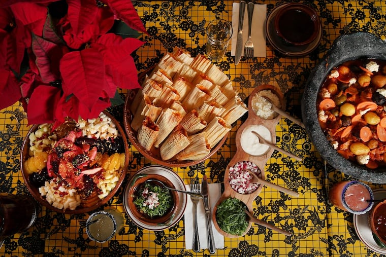 A Christmas feast, including pork pozole (bottom), ensalada de Noche Buena (Christmas Eve salad, left), chicken tamales (top) and bacalao (cod stew, right), is pictured at El Rey on Chestnut Street on Thursday, Dec. 7, 2017. TIM TAI / Staff Photographer