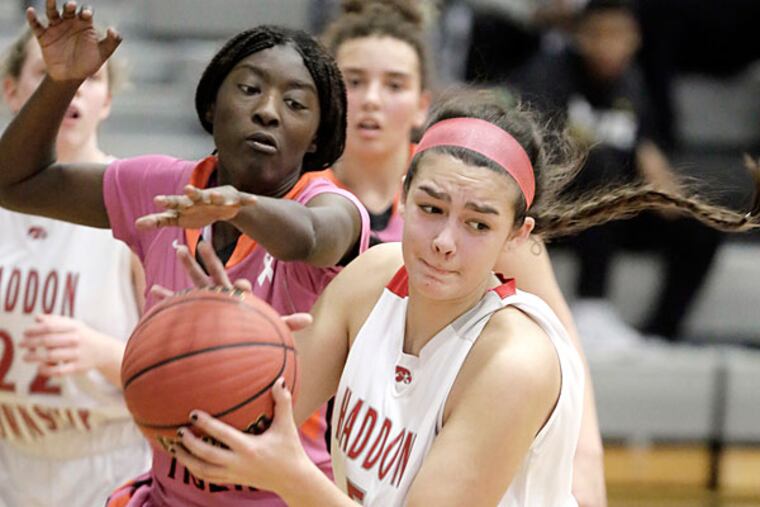 Woodrow Wilson's # 4 Sharae Blackshear tries to knock a rebound away from Haddon Twp's # 5 Bella Preziosi in the 2nd half of the Haddon Twp. vs Woodrow Wilson H.S. girls basketball game at Bishop Eustace H.S. on January 31, 2015. (Elizabeth Robertson/Staff Photographer)