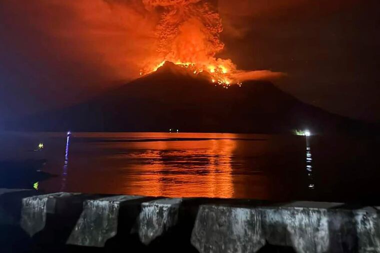 In this photo released by Sitaro Regional Disaster Management Agency (BPBD Sitaro), hot molten lava glows at the crater of Mount Ruang as it erupts in Sanguine Islands, Indonesia, Wednesday, April 17, 2024.