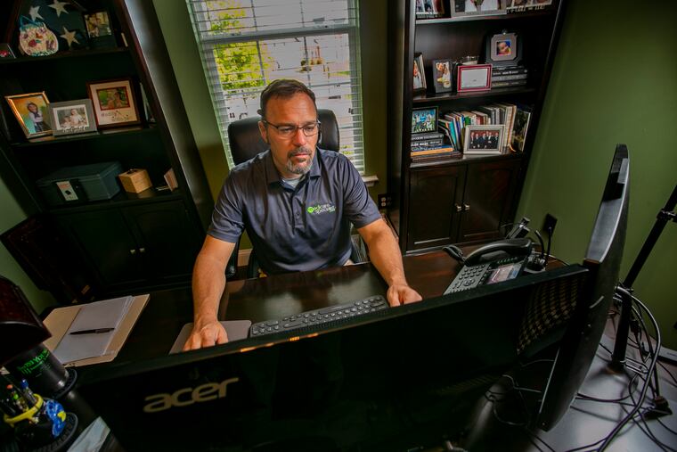 James Long, a health-care insurance broker at his computer inside his home office in Royersford, helps people that have lost "job-based health insurance" during the COVID-19 pandemic.