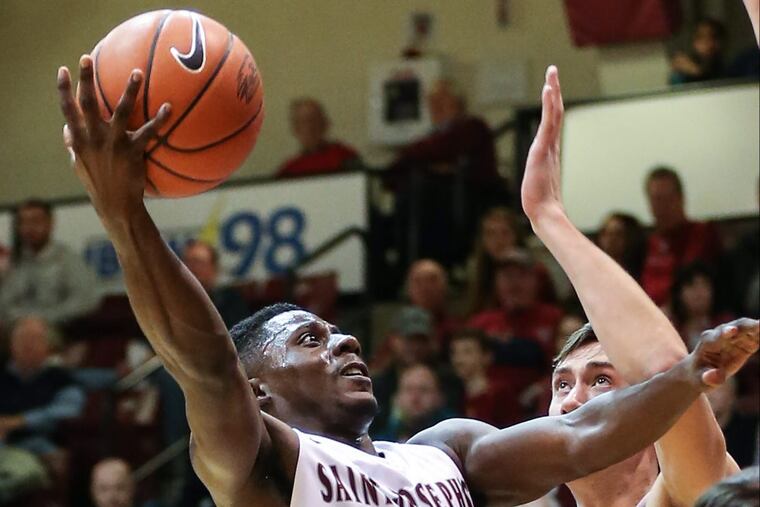St. Joseph’s senior guard Shavar Newkirk takes a shot over Lafayette’s Lukas Jarrett during the second half at The Hagan Arena Thursday, December 22, 2016.