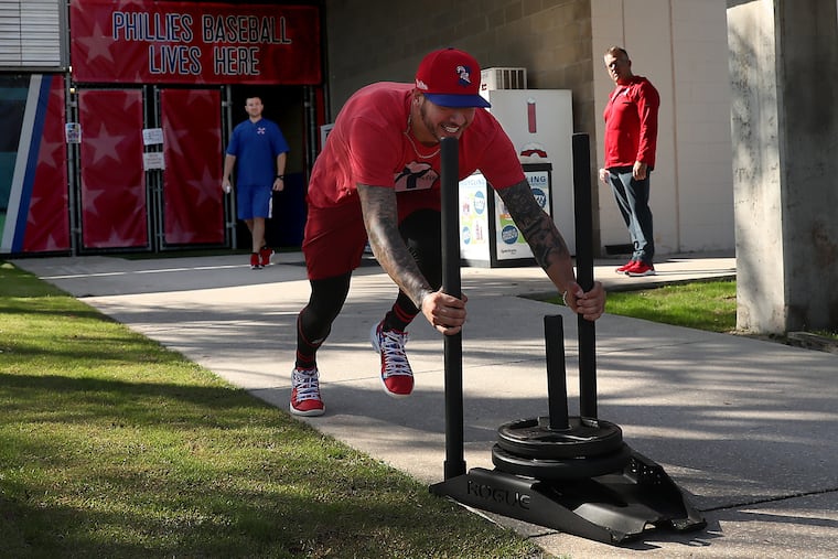 Pitcher Vince Velasquez pushes a weighted sled at the Phillies’ training facility on Tuesday before the start of spring training.