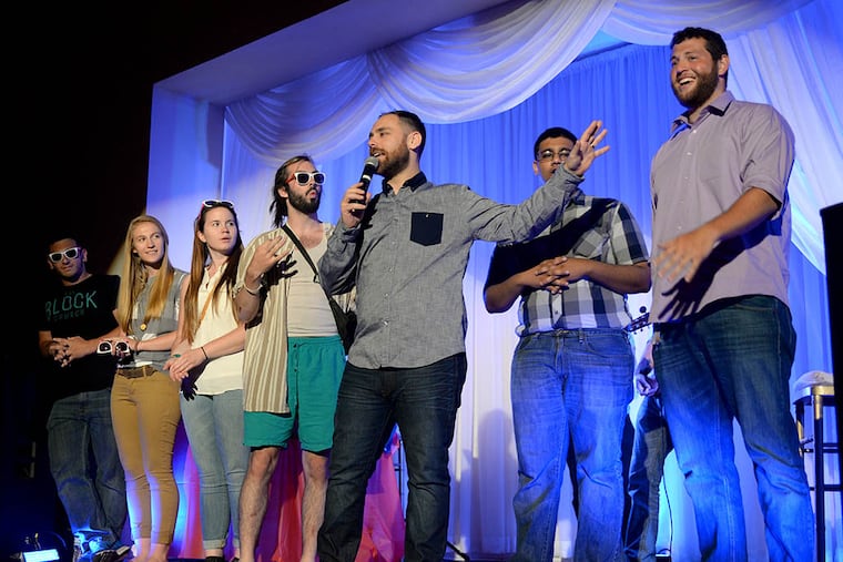 Founding and lead pastor Joey Furjanic (center), of the Block Church, recognizes the Port Richmond church’s summer interns. (TOM GRALISH / STAFF PHOTOGRAPHER)