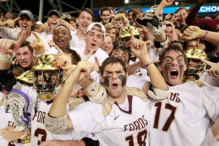 Players (from left to right) Jake Hervada, Ben Euler, and Sam Denious celebrate the Fords' victory in the final of the Inter-Ac Challenge at PPL Park . (CHARLES FOX / Staff Photographer)