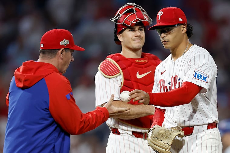 Phillies pitcher Jesús Luzardo (right) hands the ball to manager Rob Thomson as he exits Game 2 of the NLDS against the Los Angeles Dodgers in the seventh inning.