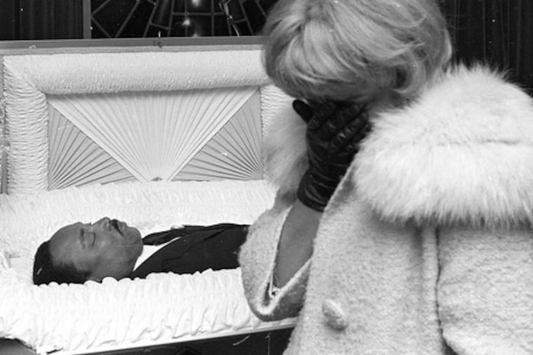 An unidentified woman mourns as she walks past the body of slain civil-rights leader Martin Luther King Jr., who was shot dead on April 4, 1968.
