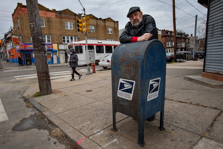 Ian Abrams of Philadelphia at a blue collection box at 51st Street and Chester Avenue. Abrams' check was stolen from the box, then duplicated and forged for $15,000.