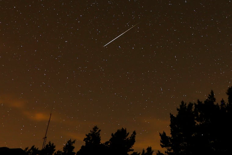 In this long exposure file photo, a Perseid meteor streaks across the night sky. The skies will be moon-less during the Perseid peak late Wednesday night into Thursday morning, but will clouds get in the way?