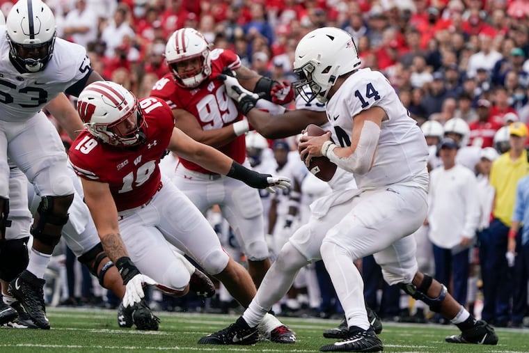 Penn State's Sean Clifford tries to get away from Wisconsin's Nick Herbig during their game last week.