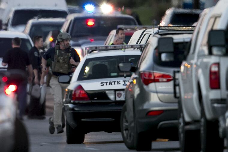 A law enforcement officer runs on Brodie Lane in Austin, Texas, moments after an explosion on Tuesday.