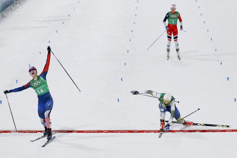 Jessica Diggins, left, of the United States, celebrates after winning the gold medal past Stina Nilsson, of Sweden, in the during women's team sprint freestyle cross-country skiing final at the 2018 Winter Olympics in Pyeongchang, South Korea, Wednesday, Feb. 21, 2018.