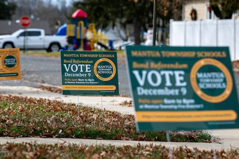 Yard signs in the Mantua Township School District on Monday ahead of the election on a bond referendum.