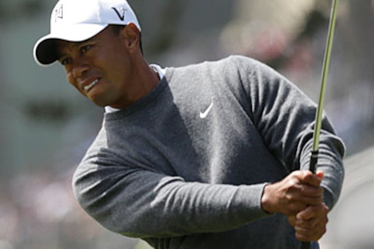 Tiger Woods finished the first round of the U.S. Open with a 1-under-par 69, three behind the leader. (Charlie Riedel/AP Photo)