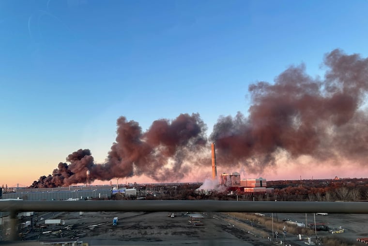 Smoke rises as a recycling facility burns at 1400 S Front St. in Camden as seen from the Walt Whitman Bridge Friday, Feb. 21, 2025.
