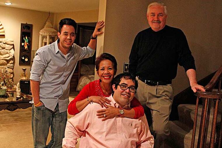 Ed Carter II with brother Brandon (left), his mother Aida and his Ed Carter. (Ron Cortes/Staff Photographer)