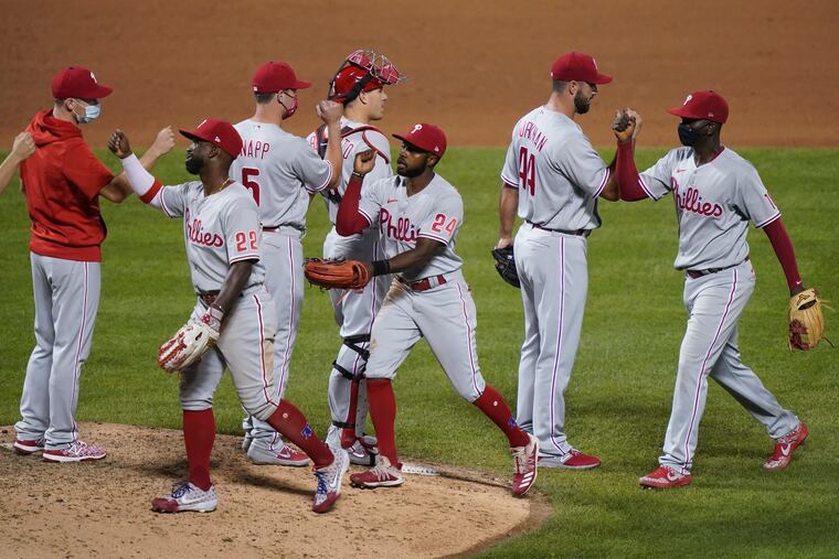 The Phillies celebrate Friday after beating the Mets.