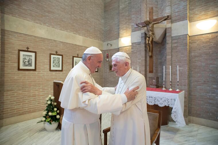 Pope Francis, left, embraces Emeritus Pope Benedict XVI, at the Vatican in 2017.