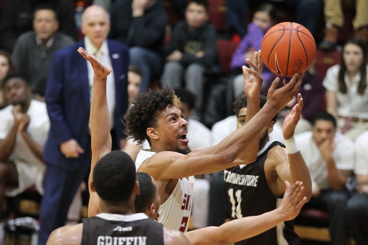 Charlie Brown, center, of St. Joseph’s is frustrated as tries to go up for a shot against the defense of St. Bonaventure during the 2nd half on Feb. 12, 2019.